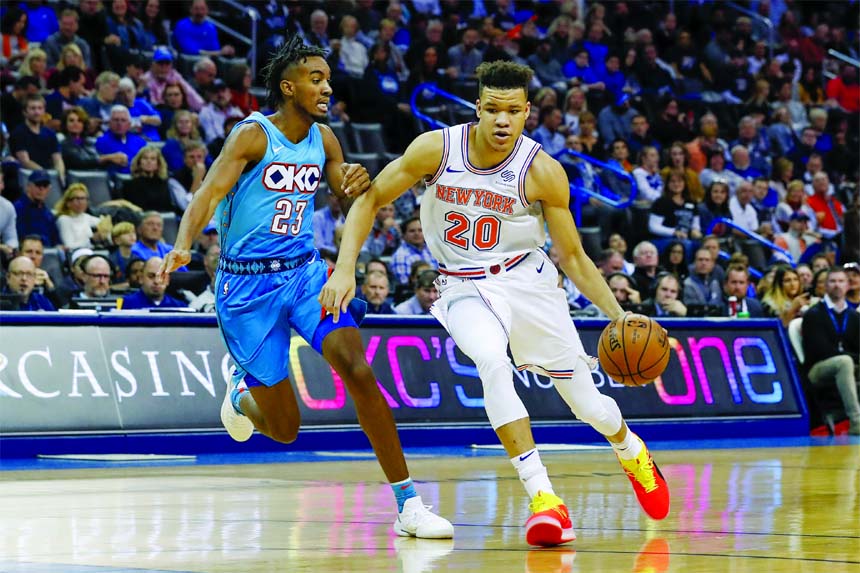 New York Knicks forward Kevin Knox (20) drives to the basket around Oklahoma City Thunder guard Terrance Ferguson (23) during the first half of an NBA basketball game in Oklahoma City, Wednesday.