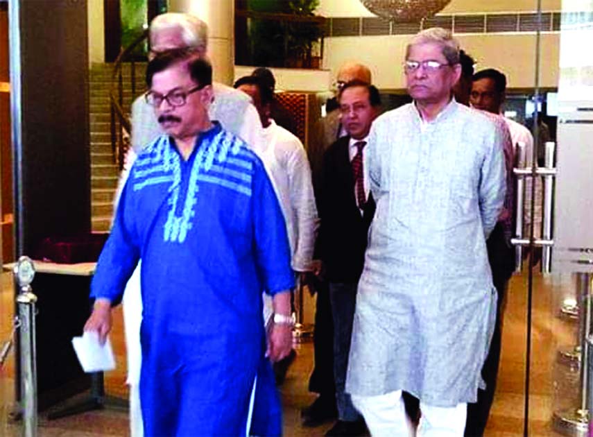Convener of Nagorik Oikya Mahmudur Rahman Manna and BNP Secretary General Mirza Fakhrul Islam Alamgir among others coming out from Dr. Kamal Hossain's Chamber at Motijheel after a meeting held on Thursday.