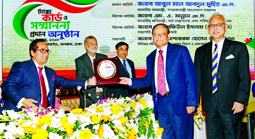 Habibur Rahman, Chairman, Board of Directors of Pubali Bank Limited, receiving the Highest Taxpayer Award in the banking category under the large tax payers' unit in 2017-18 from the State Minister for Finance and Planning M A Mannan at Sonargaon Hotel i