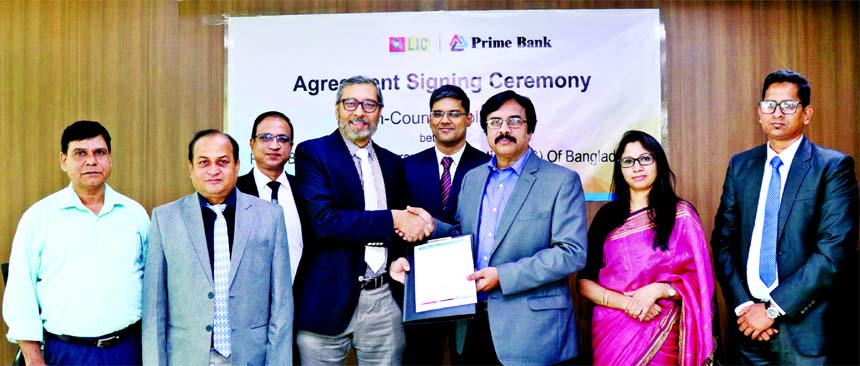 Syed Faridul Islam, DMD and Chief Risk Officer of Prime Bank Limited and A Dasgupta, CEO of LIC Bangladesh Limited, exchanging an agreement signing document for pan-country collection at the Bank's head office in the city recently. Under the deal, LIC Ba