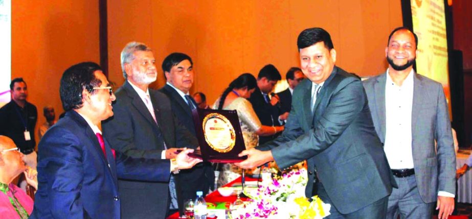 Rajesh Surana, CEO of LafargeHolcim Bangladesh, receiving the Highest Taxpayer Award in the cement manufacturing category in 2017-18 from the State Minister for Finance and Planning M A Mannan at Sonargaon Hotel in the city recently. Md. Mosharraf Hossain