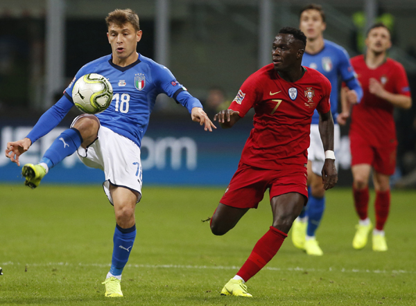Italy's Nicolo Barella (left) and Portugal's Bruma challenge for the ball during the UEFA Nations League soccer match between Italy and Portugal at the San Siro Stadium in Milan on Saturday.