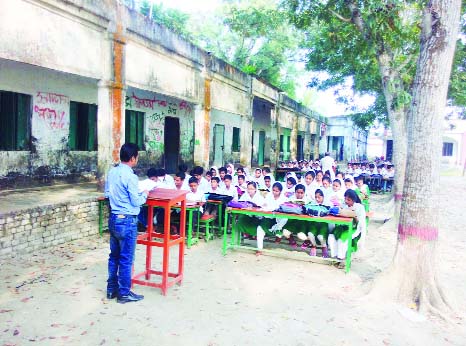 KHULNA: Students of Shahidpur Khan A Sobur High School in Terokhada Upazila attending classes under open sky as the school building is dilapidated and risky. This nap was taken yesterday.