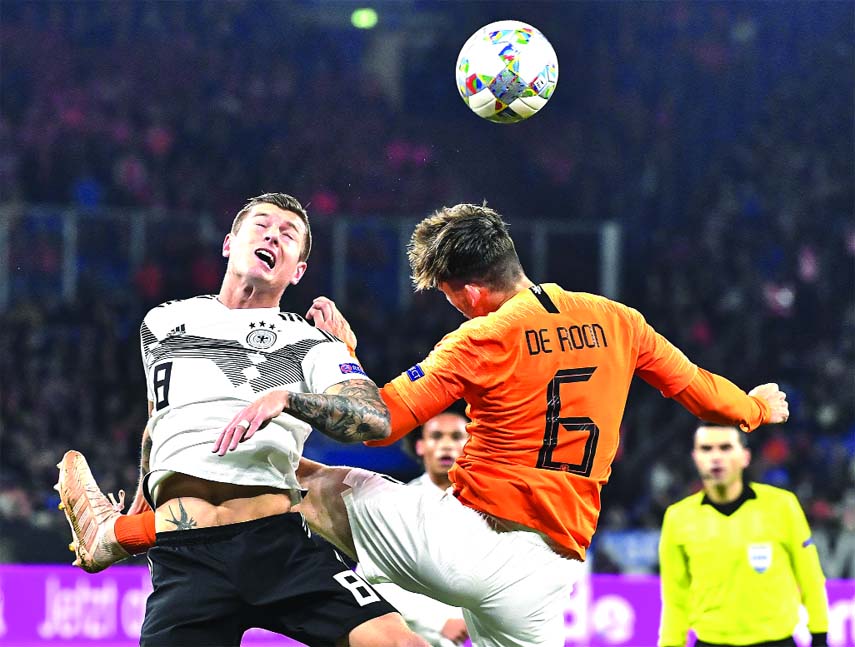Germany's Toni Kroos (left) and Netherland's Marten de Roon challenge for the ball during the UEFA Nations League soccer match between Germany and The Netherlands in Gelsenkirchen on Monday.