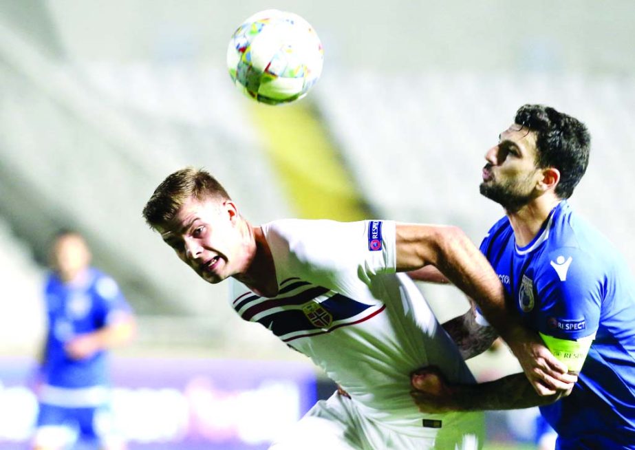 Norway's Alexander Sorloth (left) duels for the ball with Cyprus' Giorgos Merkis during the UEFA Nations League soccer match between Cyprus and Norway at GSP stadium in Nicosia, Cyprus on Monday.
