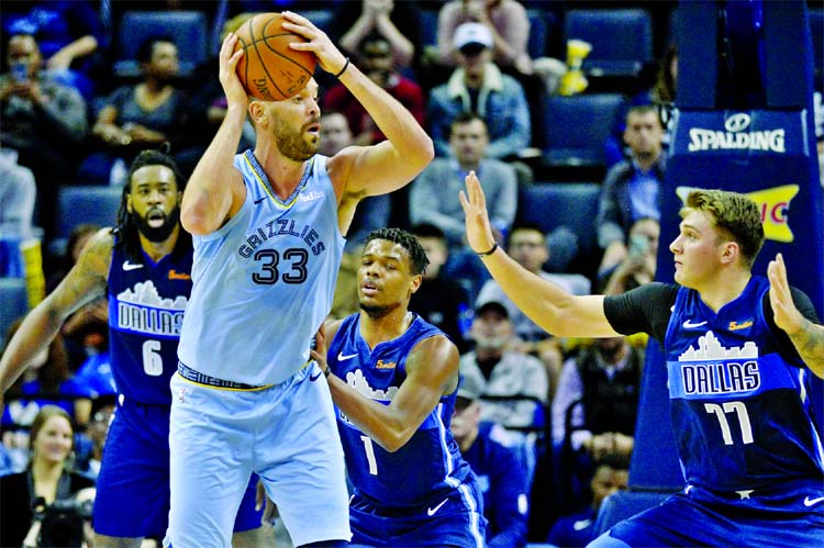 Memphis Grizzlies centerM arc Gasol (33) controls the ball against Dallas Mavericks guard Dennis Smith Jr. (1) and forward Luka Doncic (77) in the first half of an NBA basketball game in Memphis, Tenn on Monday.