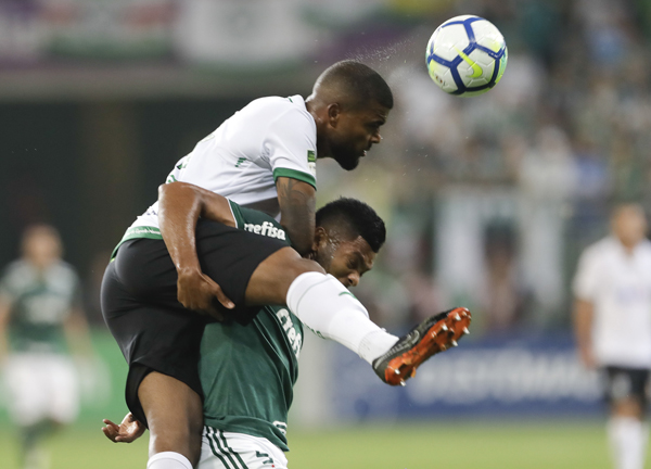 Palmeiras' Borja (right) fights for a ball with America Mineiro's Messias,during a Brazilian Championship soccer match in Sao Paulo, Brazil on Wednesday.