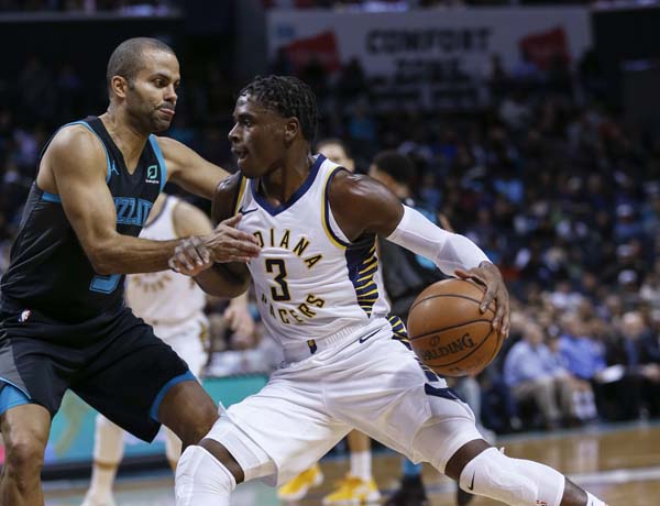 Indiana Pacers guard Aaron Holiday (right) drives as Charlotte Hornets guard Tony Parker defends during the second half of an NBA basketball game in Charlotte, N.C. on Wednesday.