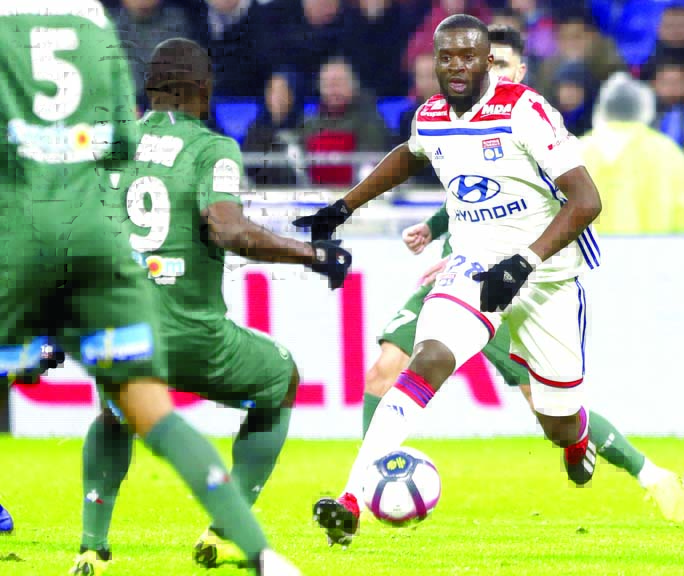 Lyon's Tanguy Ndombele (right) duels for the ball with Saint-Etienne's Yannis Salibur during the French League One soccer match between Lyon and Saint-Etienne at the Stade de Lyon, near Lyon, France on Friday.