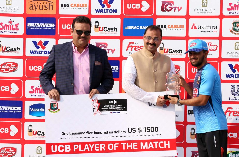 Mominul Haque (right) of Bangladesh receiving the Man of the Match Award from AJM Nasir Uddin (centre), Mayor of Chattogram City Corporation after the first Test match between Bangladesh and West Indies at Zahur Ahmed Chowdhury Stadium in Chattogram on Sa