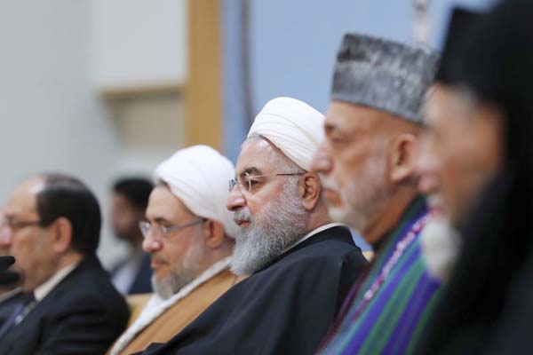 Iranian President Hassan Rouhani, center, attends an annual Islamic Unity Conference in Tehran, Iran on Saturday.
