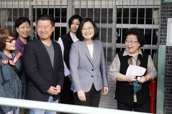 Taiwanese President Tsai Ing-wen, second right, lines up with people at a polling station on Saturday in Taipei, Taiwan.