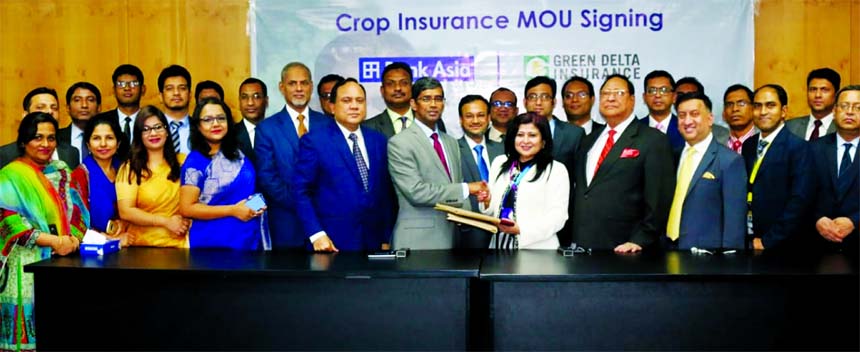 Farzana Chowdhury, Managing Director of Green Delta Insurance Company Limited (GDICL) and Md. Arfan Ali, Managing Director of Bank Asia Limited, exchangning an agreement signing document at GDICL head office in the city on Thursday. Under the deal, Green