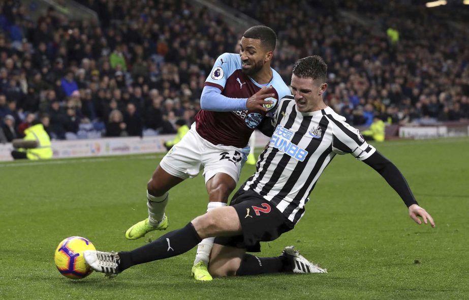 Burnley's Aaron Lennon (left) and Newcastle United's Ciaran Clark battle for the ball during the English Premier League soccer match at Turf Moor, Burnley, England on Monday.