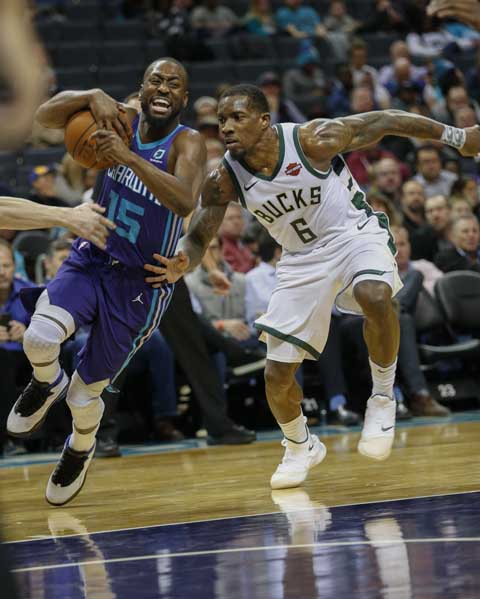 Charlotte Hornets guard Kemba Walker (left) drives against Milwaukee Bucks guard Eric Bledsoe (6) in the second half of an NBA basketball game in Charlotte, N.C. on Monday.