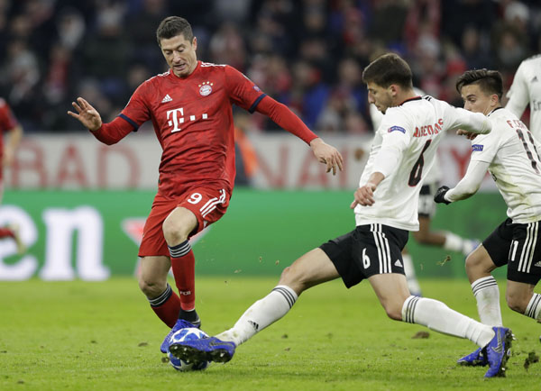 Bayern forward Robert Lewandowski (left) and Benfica's Ruben Dias challenge for the ball during the Champions League group E soccer match between FC Bayern Munich and Benfica Lisbon in Munich, Germany on Tuesday.