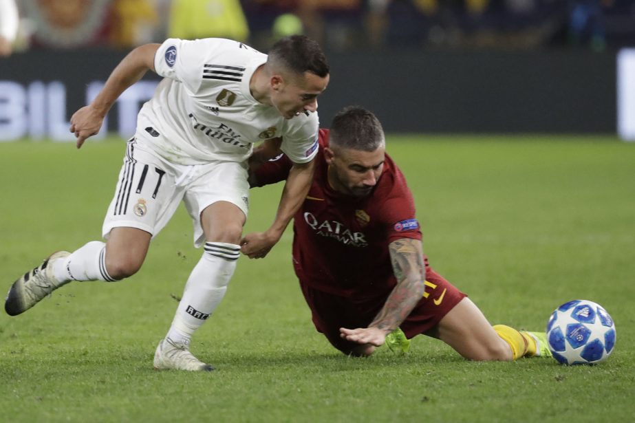 Roma defender Aleksandar Kolarov (right) fights for the ball against Real forward Lucas Vazquez during a Champions League, Group G soccer match between Roma and Real Madrid at the Rome Olympic stadium on Tuesday.