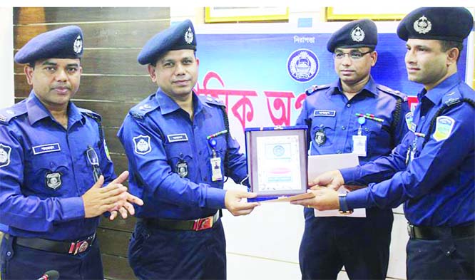 NETRAKONA: Joydeb Chowdhory, SP, Netrakona giving crest and certificate to Additional Police Super of Netrakona Sadar Circle Mohammad Faqruzzaman Jewel as the best circle officer of the district at his Official Conference Room on Sunday.