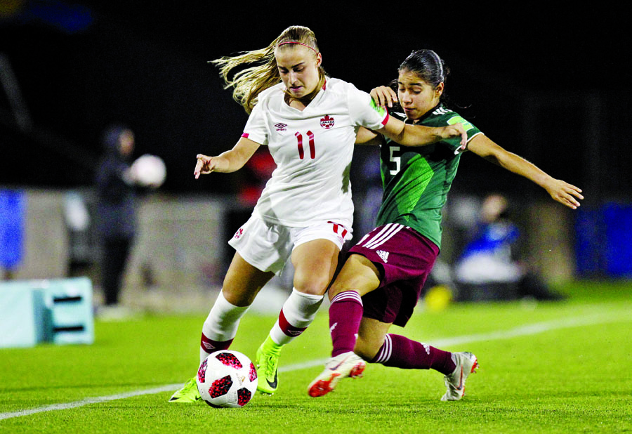 Kaila Novak of Canada (left) fights for the ball with Ximena Rios of Mexico during a 2018 FIFA U-17 Women's World Cup semifinal soccer match in Montevideo, Uruguay on Wednesday.