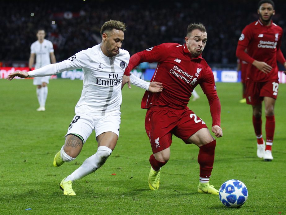 PSG forward Neymar (left) challenges for the ball with Liverpool midfielder Xherdan Shaqiri during a Champions League Group C soccer match between Paris Saint Germain and Liverpool at the Parc des Princes stadium in Paris on Wednesday.