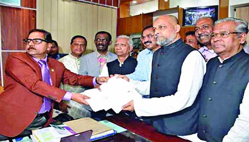 Awami League nominated candidate for Chattogram-11 Constituency (Bandar) MA Latif submitting nomination papers to the Returning Officer on Wednesday.