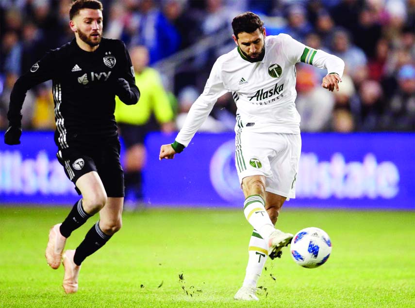 Portland Timbers midfielder Diego Valeri (8) shoots on net ahead of Sporting Kansas City midfielder Ilie Sanchez (left) during the first half in the second leg of the MLS soccer Western Conference championship in Kansas City on Thursday.