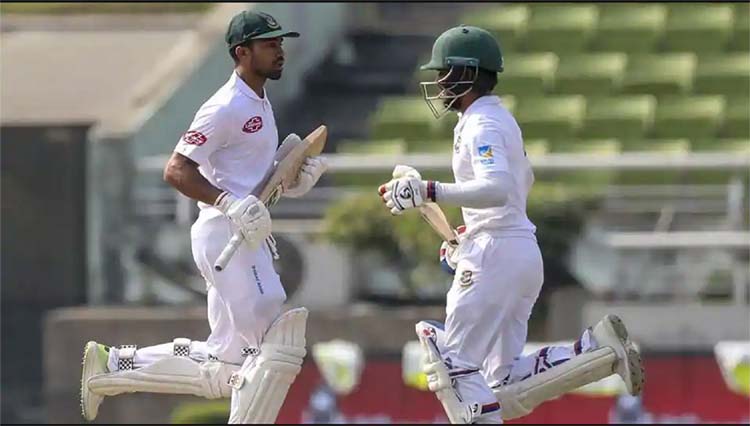 Bangladesh's Mominul Haque (R) and Shadman Islam (L) running between the wicket during the first day of the second Test cricket match between Bangladesh and West Indies at the Sher-e-Bangla National Cricket Stadium on Friday.