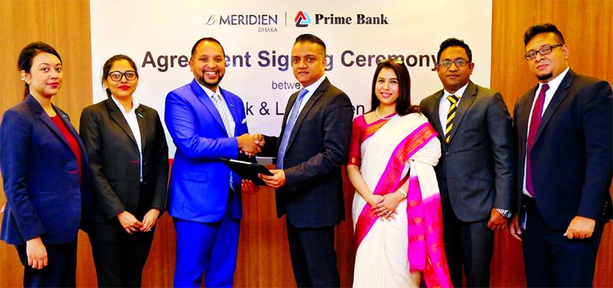 ANM Mahfuz, Head of Consumer Banking of Prime Bank Limited and Anwar Hossain, Director (Sales & Marketing) of Le MÃ©ridien Dhaka, exchanging an agreement signing documents at the Bank's head office in the city recently. Under the deal, the Bank's Plat