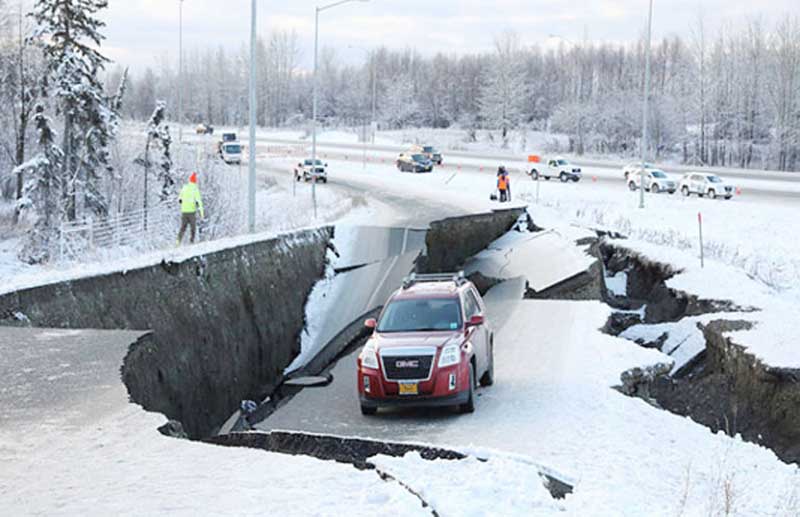 A vehicle lies stranded on a collapsed roadway near the airport after an earthquake in Anchorage, Alaska, US, on Friday.