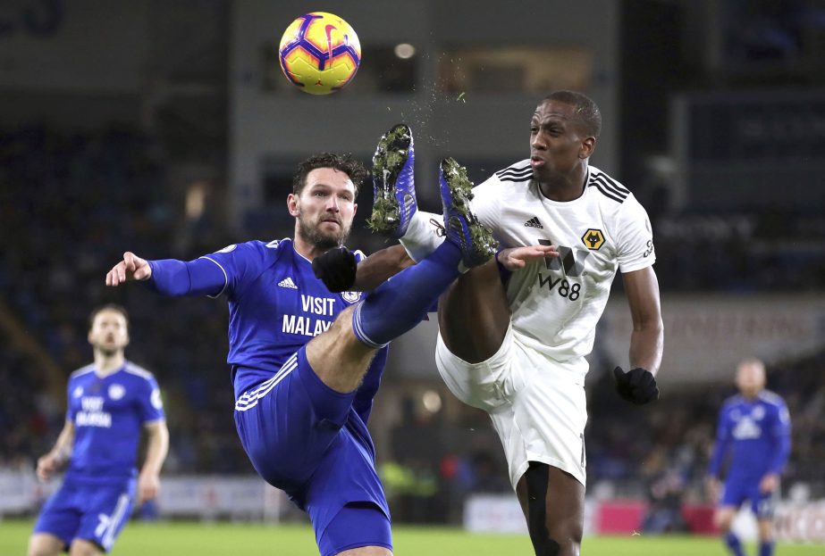 Cardiff City's Sean Morrison (left) and Wolverhampton Wanderers' Willy Boly battle for the ball during their Premier League soccer match at Cardiff City Stadium, Wales on Friday.