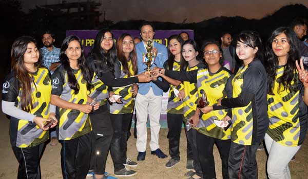 Founding Vice-Chairman of East Delta University Sayeed Al Noman (centre) handing over the championship trophy to the players of Cricket Divas, the champions of the Women's Group of the East Delta University Premier Cricket League at the ground of East De