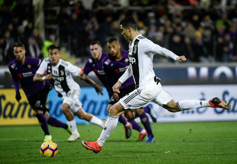 Cristiano Ronaldo (right) of Juventus hits a shot to the Fiorentina goal bar during the Serie A soccer match between Juventus and Fiorentina at Milan on Saturday.