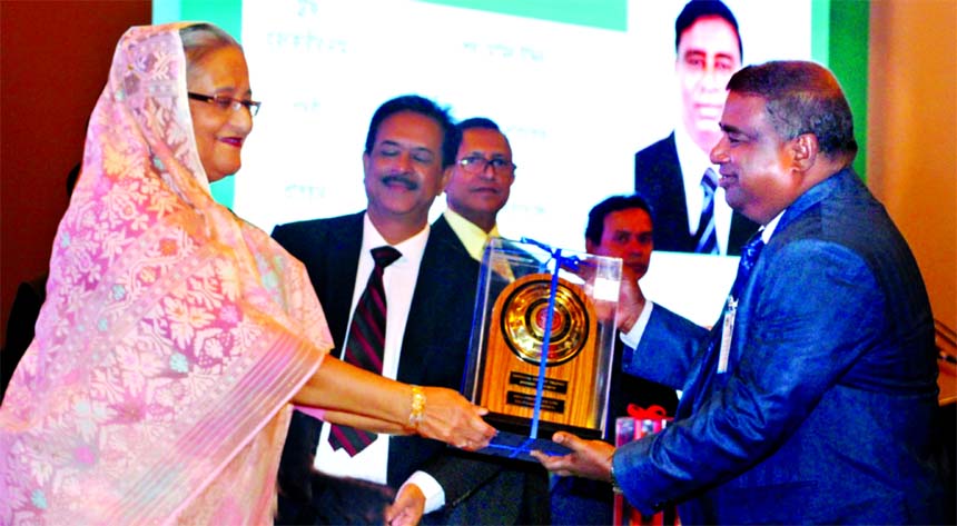 Prime Minister Sheikh Hasina, handing over the "National Export Trophy for 2015-2016 to Sk. Momin Uddin, Managing Director of Akij Footwear Limited, a sister concern of Akij Group as good perform of Footwear Exporter at a hotel in the city on Sunday.