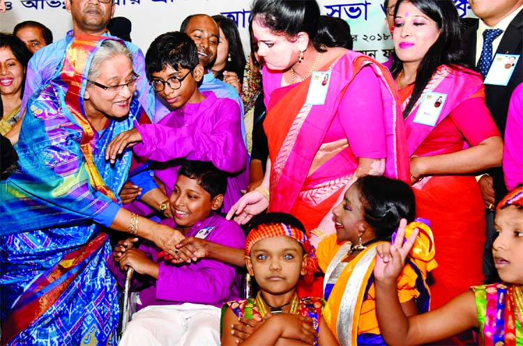Marking the 27th International Day of Persons with Disabilities, Prime Minister Sheikh Hasina exchanging greetings with the disabled children at the Bangabandhu International Conference Centre on Monday.