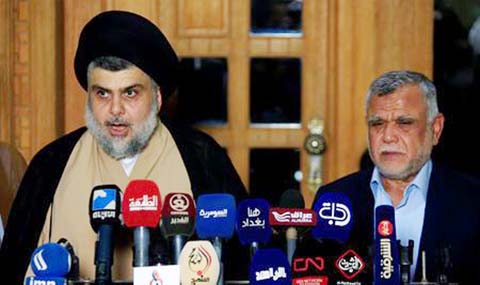 Iraqi Shi'ite cleric Moqtada al-Sadr speaks during a news conference with Leader of the Conquest Coalition and the Iran-backed Shi'ite militia Badr Organisation Hadi al-Amiri, in Najaf, Iraq.