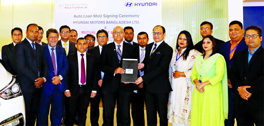 Tarek Reaz Khan, Head of SME & Retail Banking of Mutual Trust Bank Limited (MTB) and Syed Shakeel Ahmed, Managing Director of Hyundai Motors Bangladesh Limited, exchanging an agreement signing document at the automobiles head office in the city recently.