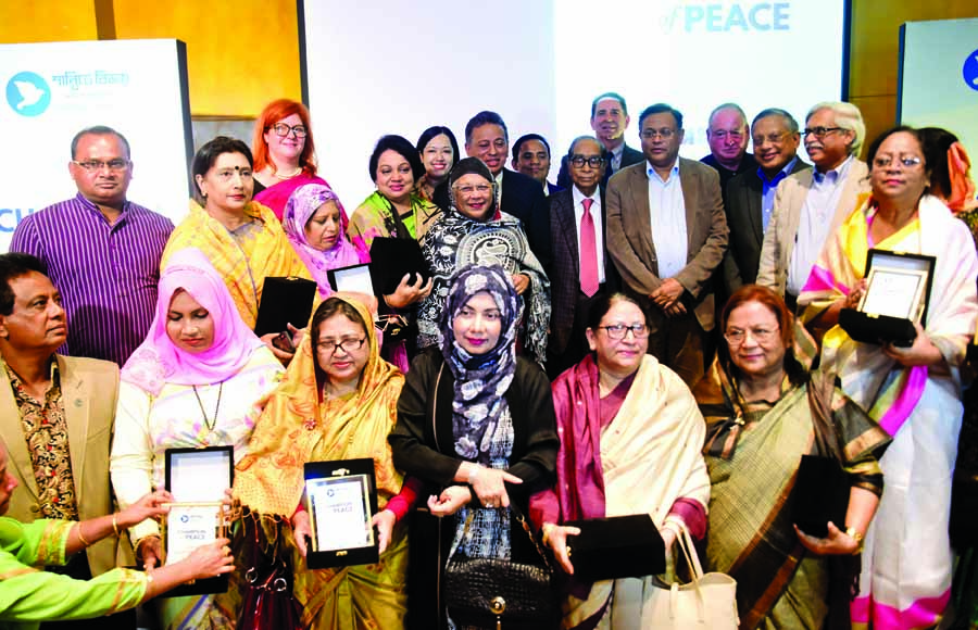 Prime Minister's Political Adviser HT Imam poses for photograph with the recipients of 'Shantite Bijoy Purashkar' organised by Democracy International at Hotel Westin in the city on Wednesday.