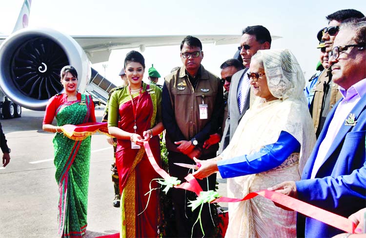 Prime Minister Sheikh Hasina cutting ribbon before visiting the newly procured Boeing 787-8 Dreamliner aircraft 'Hangsabalaka' at the Hajrat Shahjalal International Airport on Wednesday.