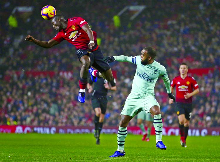 Manchester United's defender Eric Bailly clears the ball before Arsenal's Alexandre Lacazette can attempt to score during the English Premier League soccer match between Manchester United and Arsenal at Old Trafford stadium in Manchester, England on Wed
