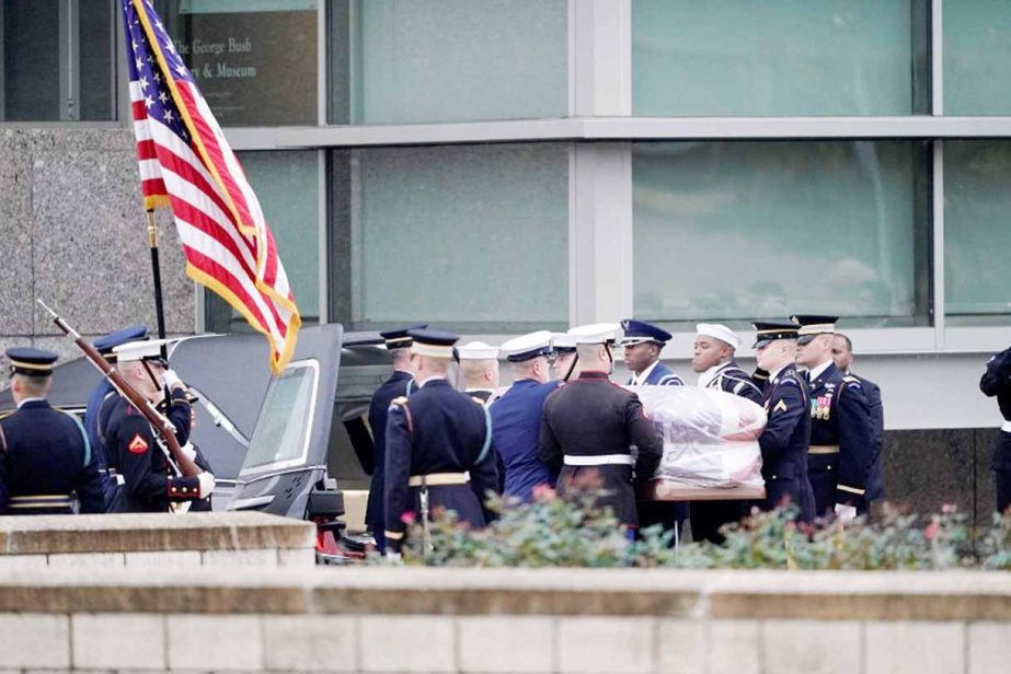 The flag-draped casket of former President George H.W. Bush is carried by a joint services military honor guard for burial at the George H.W. Bush Presidential Library and Museum in College Station, Texas, USA on Thursday.
