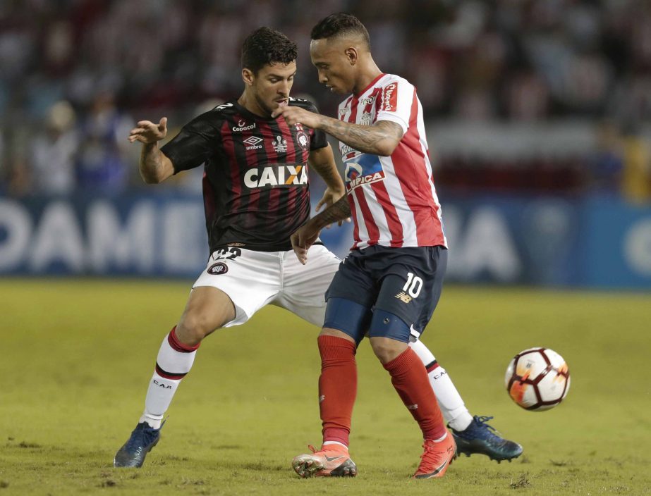 Marcinho of Brazil's Atletico Paranaense (left) fights for the ball with Jarlan Barrera of Colombia's Junior during a Copa Sudamericana first leg final match at the Metropolitano stadium in Barranquilla, Colombia on Wednesday.