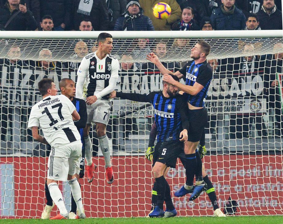 Juventus' Cristiano Ronaldo (3rd from left) heads the ball during the Serie A soccer match between Juventus and Inter Milan at the Turin Allianz stadium, Italy on Friday.