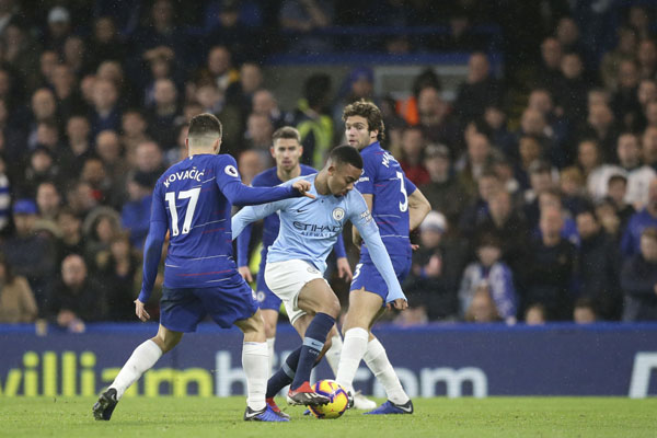 Manchester City's Gabriel Jesus (second right) goes for the ball past Chelsea's Marcos Alonso (right) Chelsea's Mateo Kovacic (second left) during the English Premier League soccer match between Chelsea and Manchester City at Stamford Bridge in London
