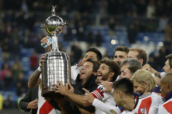 Marcelo Gallardo, coach of Argentina's River Plate, celebrates with the trophy after defeating Argentina's Boca Juniors at the Copa Libertadores final soccer match in Santiago Bernabeu stadium in Madrid, Spain on Sunday.