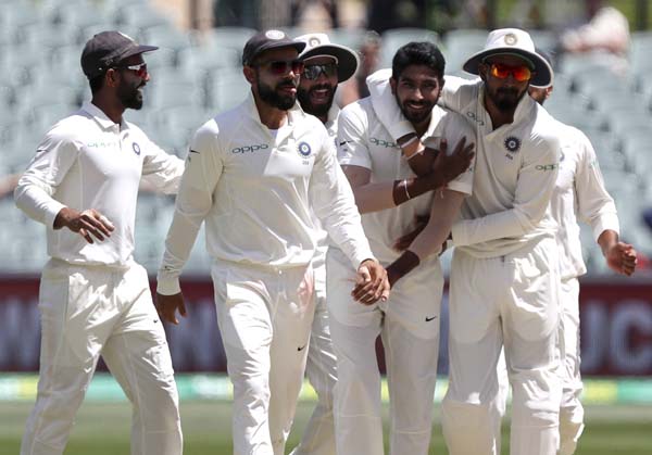 India's Jasprit Bumrah (second right) is congratulated by teammates after dismissing Australia's Shaun Marsh during the first cricket Test between Australia and India in Adelaide, Australia on Monday.