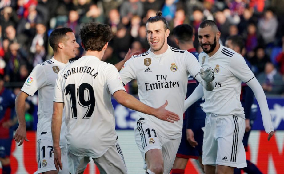 Real Madrid's Gareth Bale celebrates with Alvaro Odriozola after scoring their first goal against Huesca during their La Liga match in Huesca on Sunday.