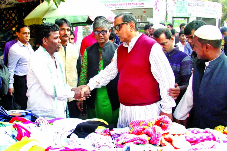 Awami League candidate Rashed Khan Menon conducting campaign in city's Purana Palton area on Monday.