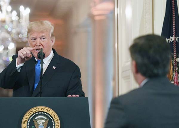 US President Donald Trump points to journalist Jim Acosta from CNN during a post-election press conference in the East Room of the White House in Washington