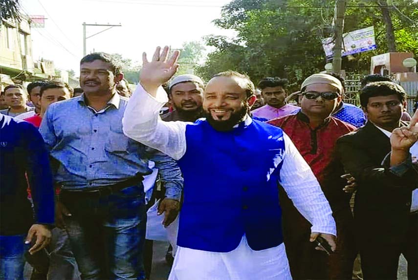 FENI: Independent candidate Sheikh Abdullah from Feni-1 seat waving to public during an election campaign at Feni on Monday.