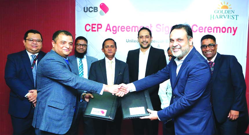 Sajib Kumar Basak, EVP of United Commercial Bank Limited (UCBL) and Samad Chowdhury, Director of Golden Harvest Group, exchanging an agreement signing document at the Banks head office in the city recently. Under the deal, employees of Golden Harvest Grou